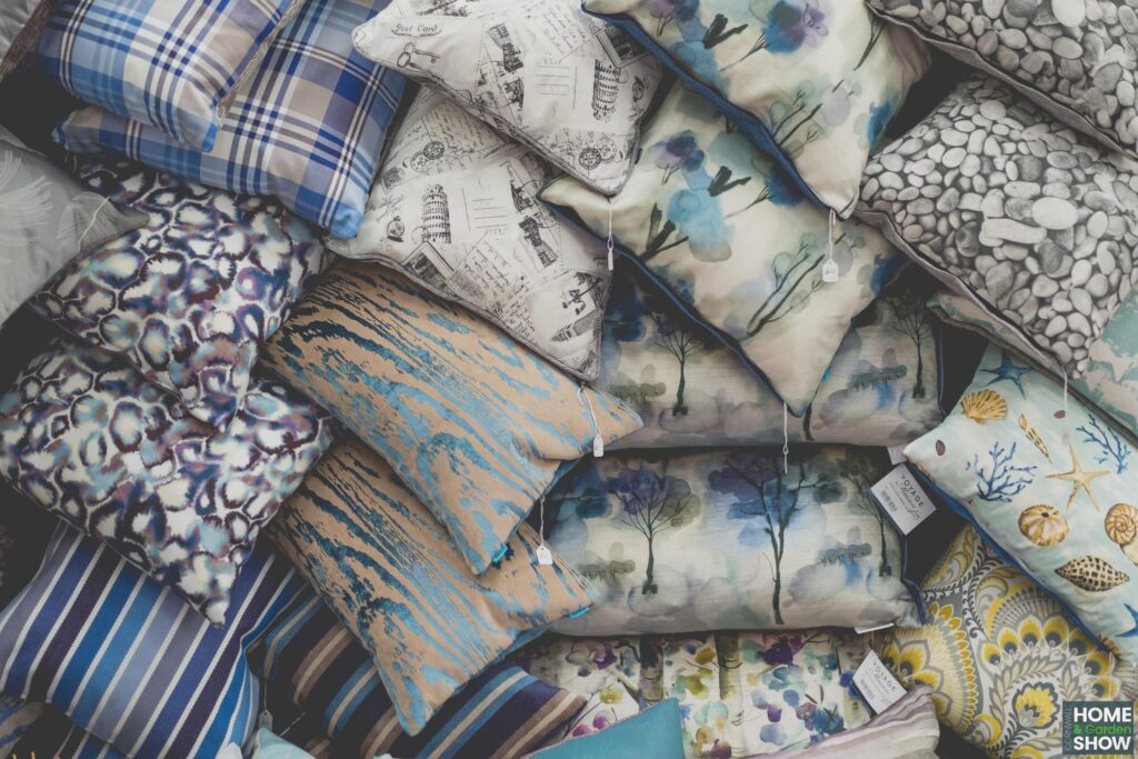 pile of decorative patterned cushions in blue and yellow at the Cornwall Home & Garden Show