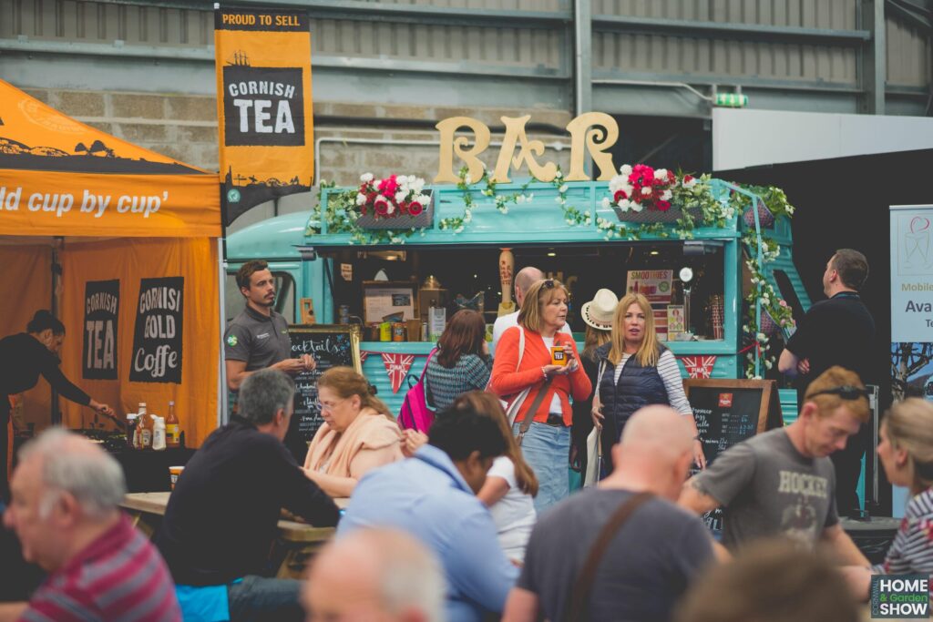 cornish tea and bar food and drinks van with seated crowd